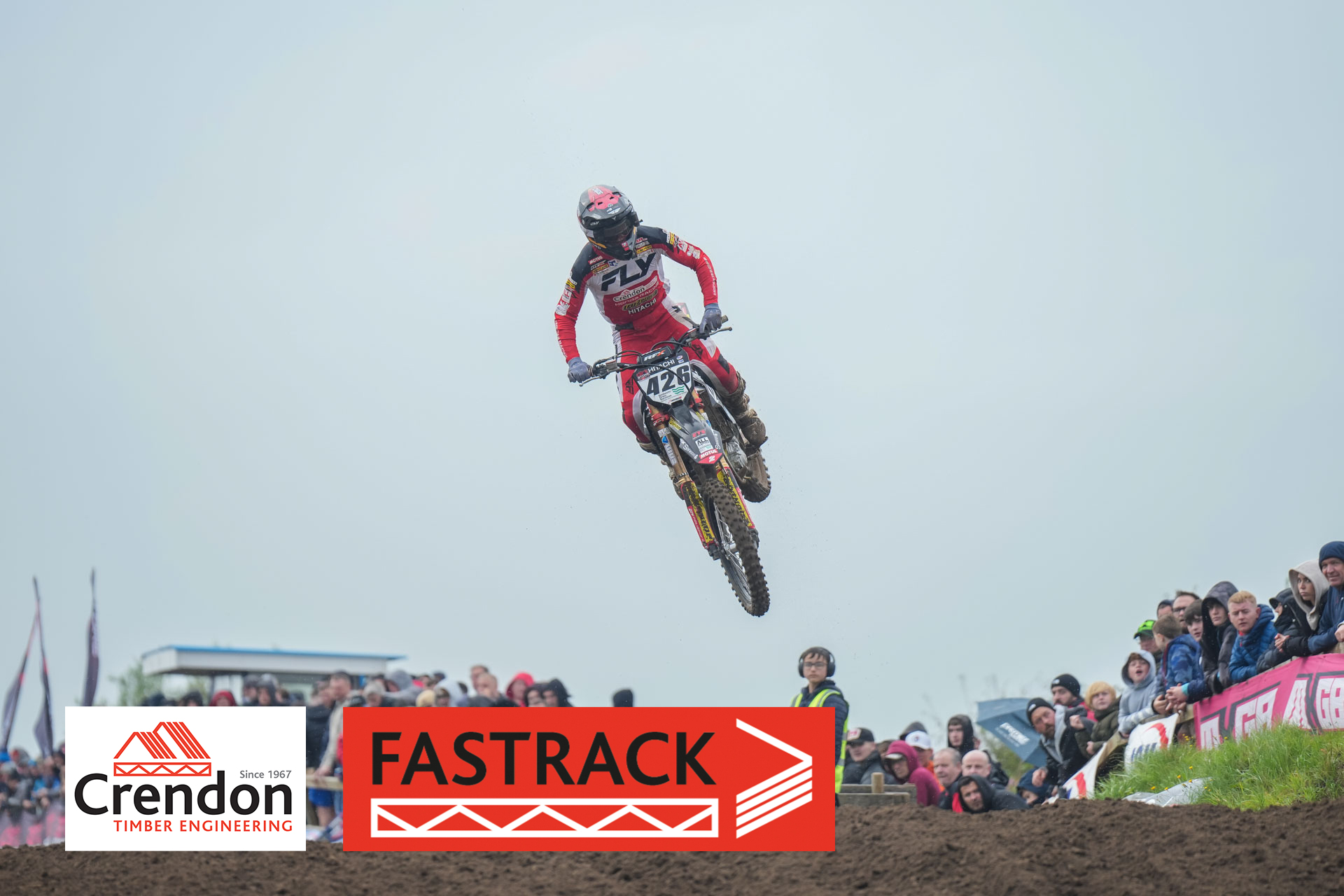 Motocross biker jumping over the hill.