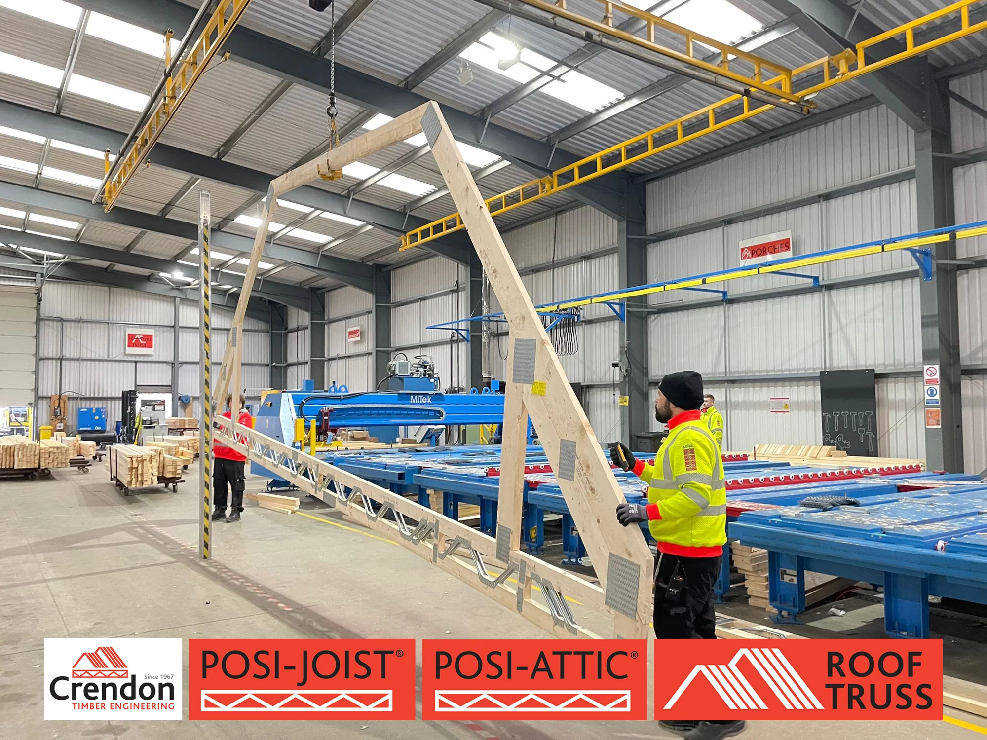 Man in warehouse holding timber Roof Truss