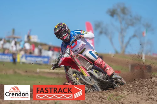 Man skidding on dirt track on motorcross bike
