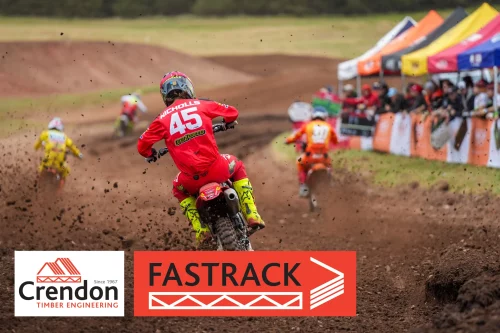 Man on motorcross bike riding through dirt track