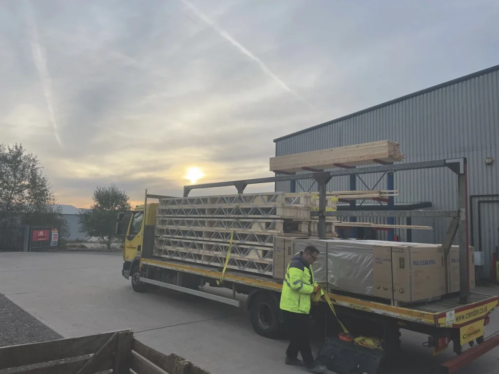 Posi joists being loaded onto the back of flatbed lorry