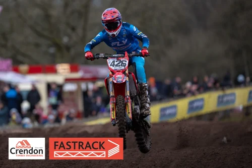 Biker in blue in air on a bike.