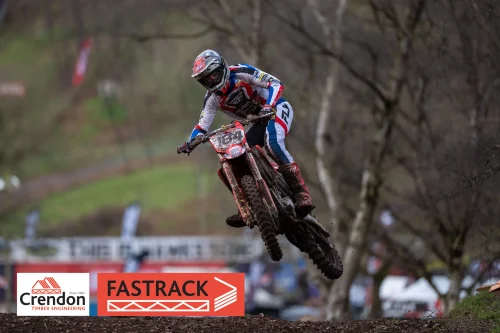 Biker in red, white and blue in the air on a bike.