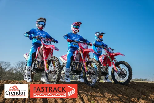 3 Crendon FASTRACK motocross riders on their bikes on a dirt mountain.