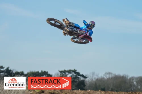 A biker in the air on his bike.