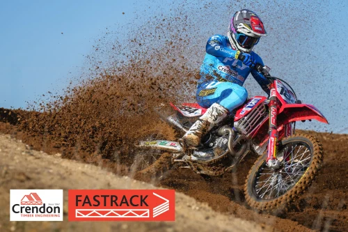 A biker going through some dirt on his bike.