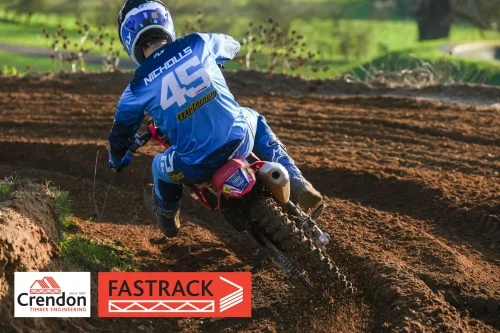 A biker riding through the dirt race track.