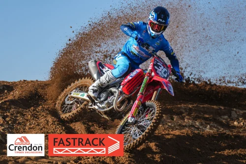 A biker riding on the dirt track.