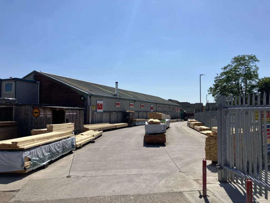 Warehouse yard with stacks of materials organised into products on a sunny day