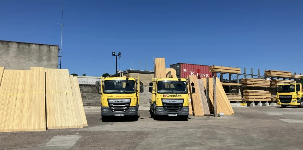 Three Crendon trucks in the loading area with products and racks of materials