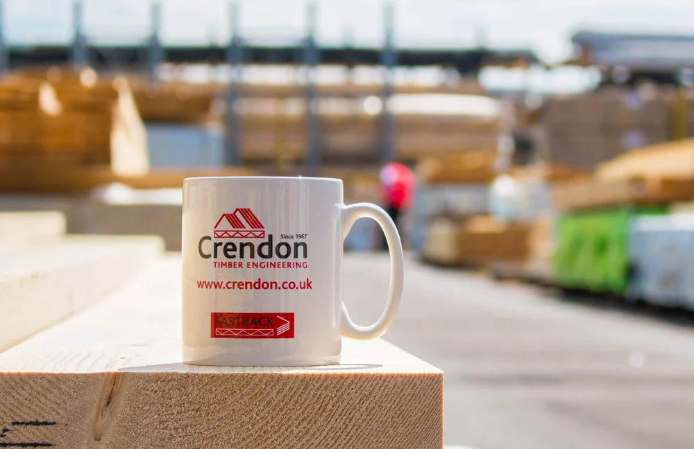 Crendon branded mug sat on timber in a outdoor storage areas
