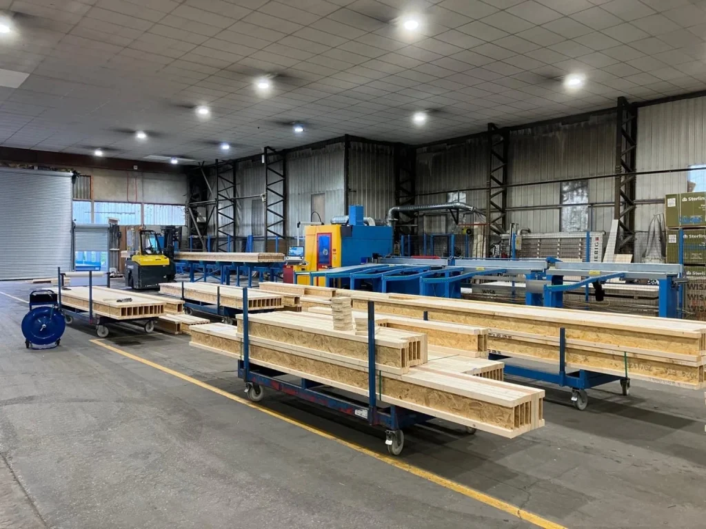 Stacks of I-Joists on trolleys inside a warehouse