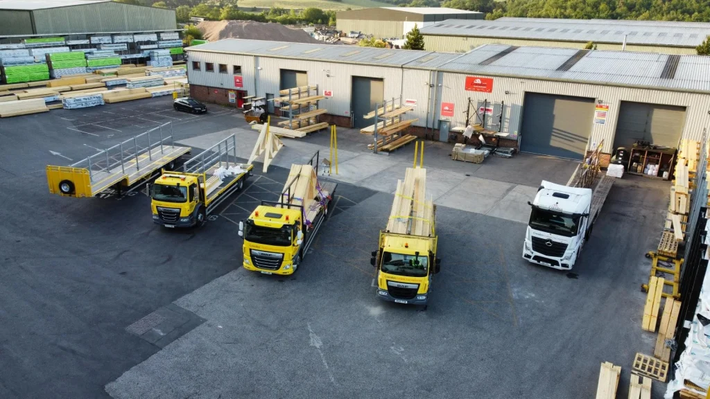 Loading bay with multiple trucks and trailers with racking holding materials