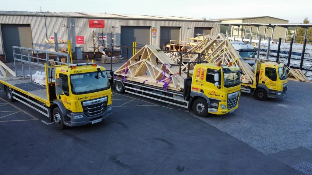 Loading bay with multiple trucks and trailers with racking holding materials