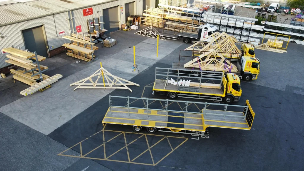 Loading bay with multiple trucks and trailers with racking holding materials
