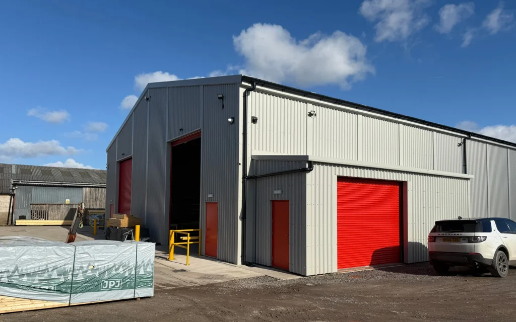 Grey warehouse with red shutter doors