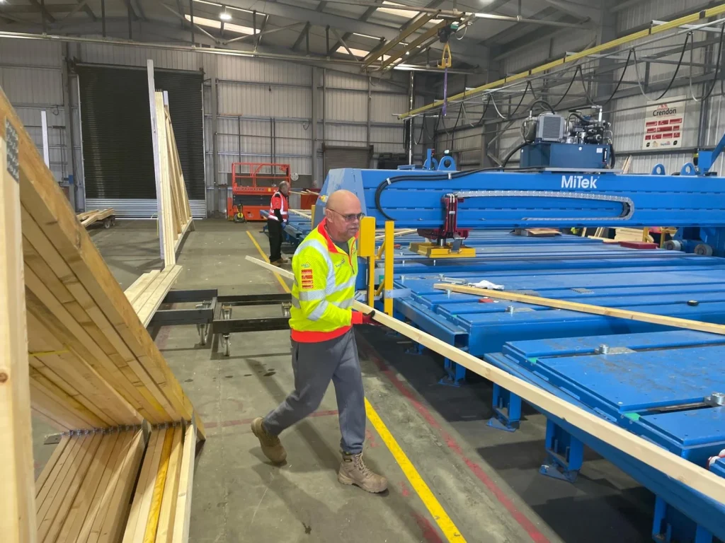 Worker moving timber length