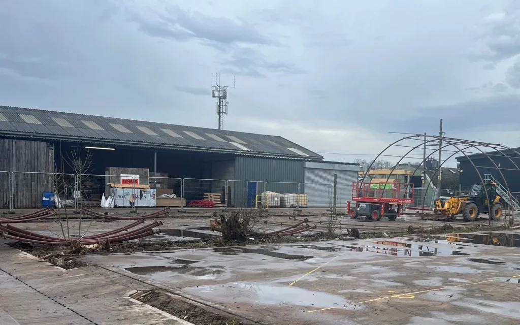 Demolition site with warehouse behind
