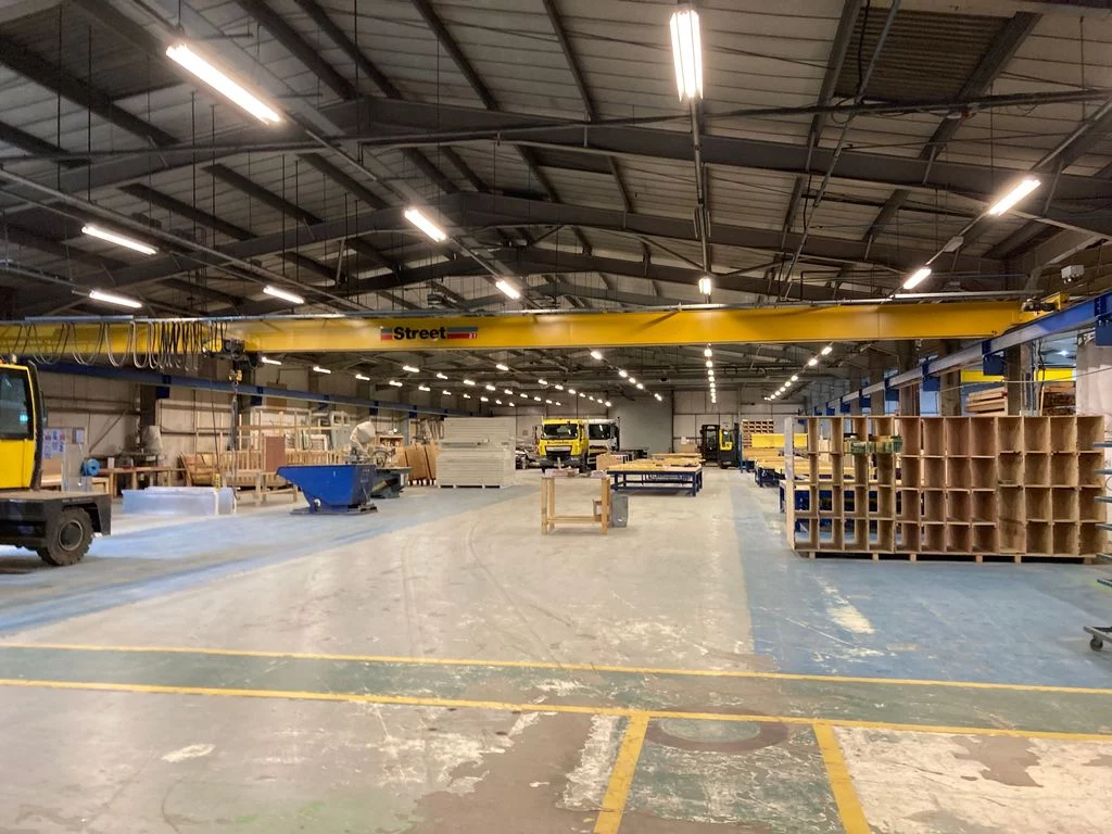 Warehouse with materials, trucks, machinery and products
