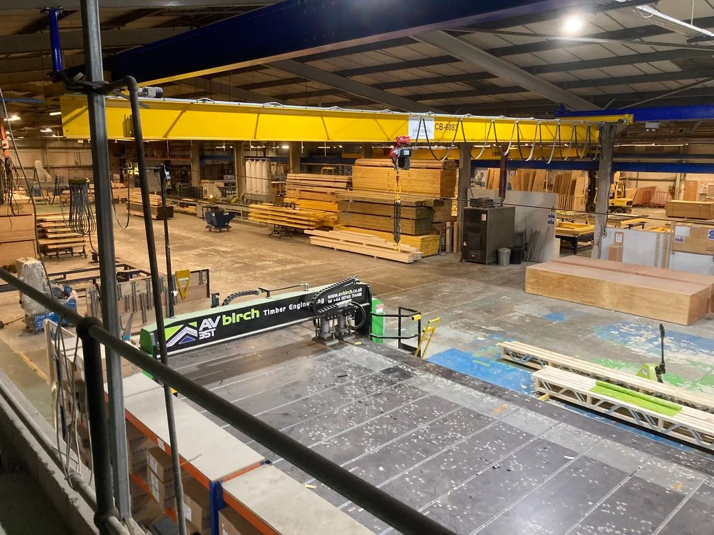 Warehouse with stacks of Posi-Joists, stacks of materials and machinery