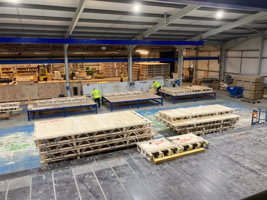 Posi-Joists in stacks in an assembly line