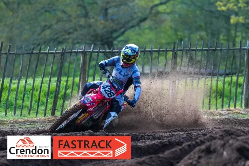 A motorcross rider skidding in the dirt track