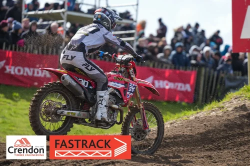 A motocross rider about to go up a dirt hill