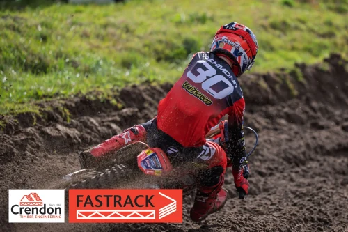 a motocross rider going round the corner on a dirt bike. 