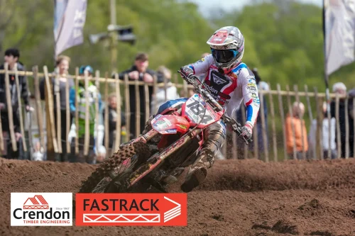 A motorcross rider going round a corner on a dirt track