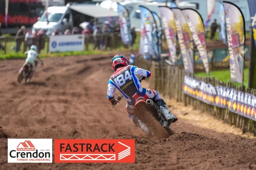 A biker on the dirt track racing the course.