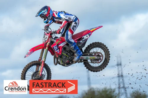 A side photo shot of a motocross rider up in the air.