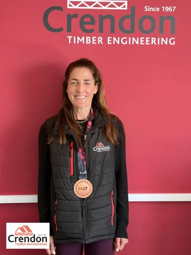 Crendon-News-Marathon-1-375x500 Woman with long brunette hair wearing a London Marathon medal 2026