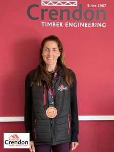 Woman with long brunette hair wearing a London Marathon medal 2026