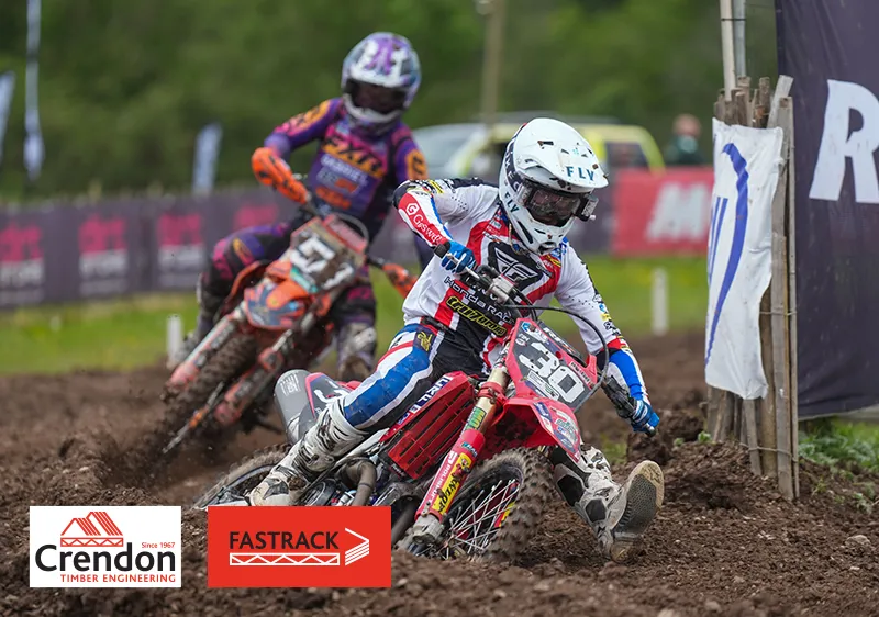 2 men on dirt bikes on a dirt track taking a corner
