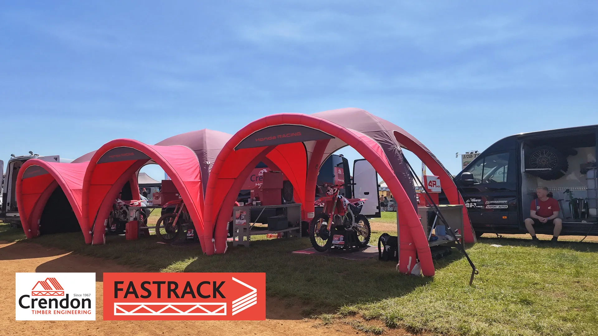 Red tents covering motocross bikes