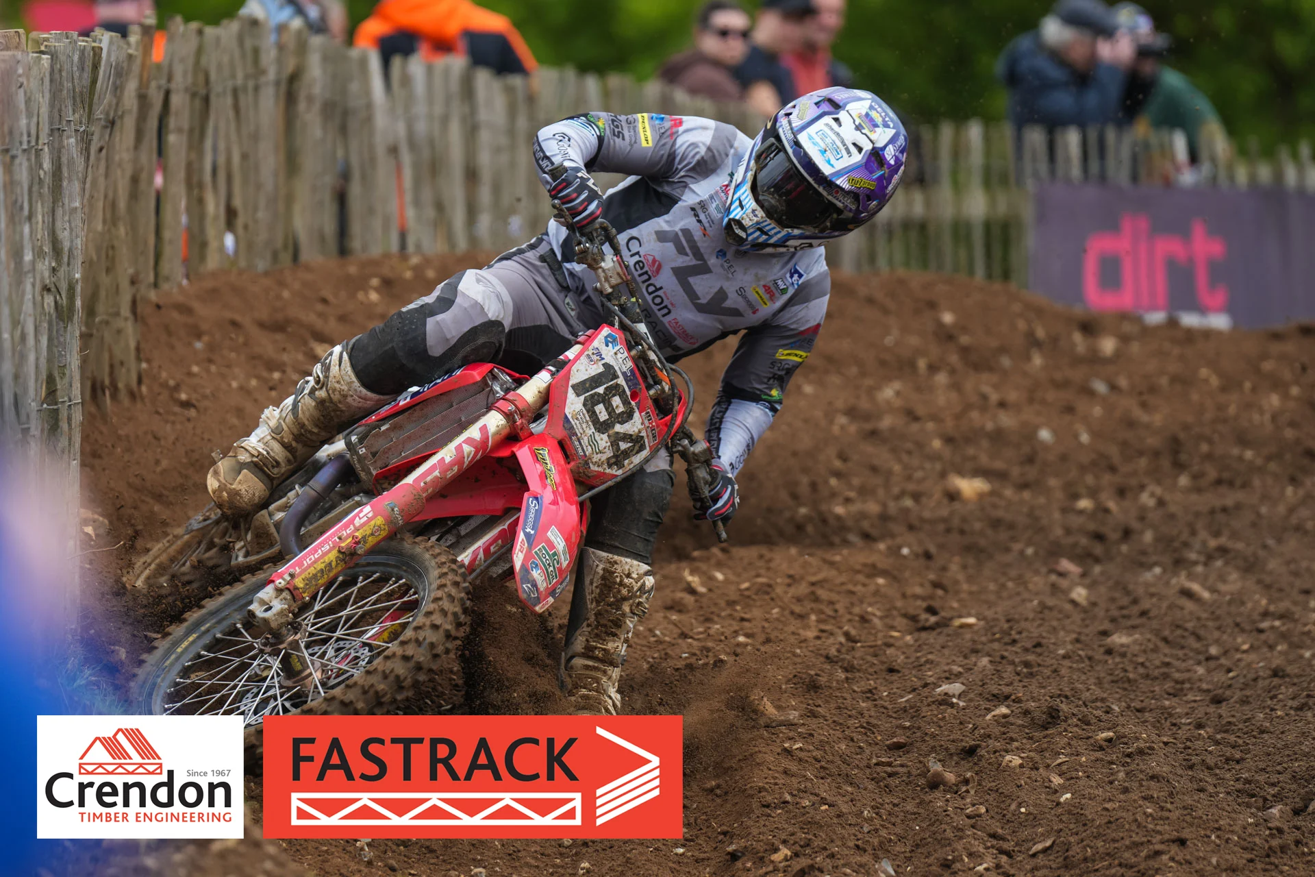 A motocross rider on his bike on a bend.