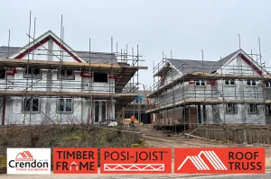 2 houses with scaffolding and wrapped in a foil like wrap.