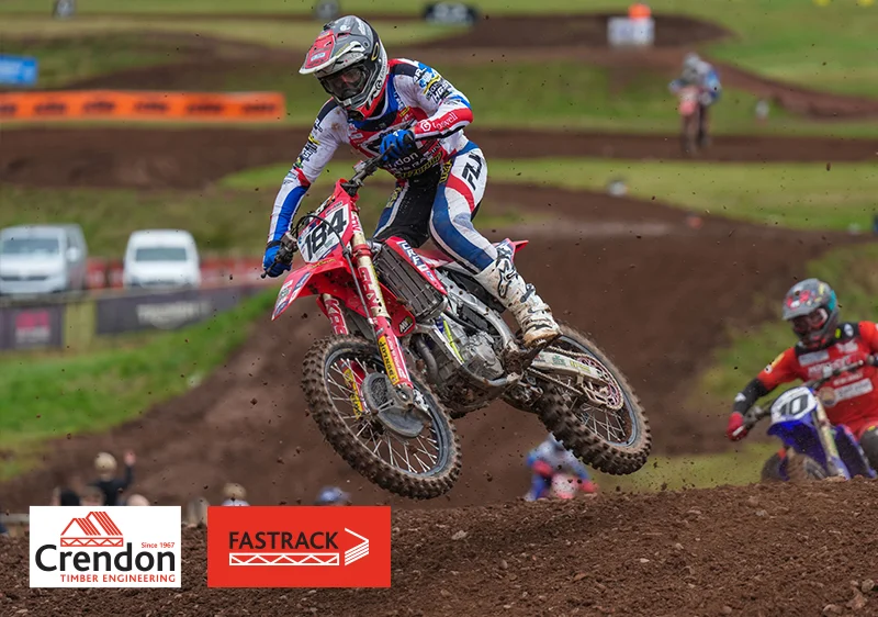 Red Dirt Bike on Course in the Air