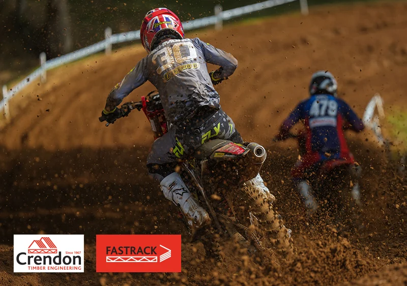 Dirt bike and rider going away from the camera with dirt kicking up