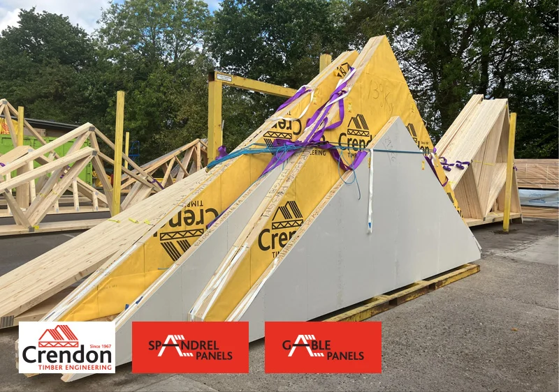 spandrel and gable panels leaning against a post in a yard